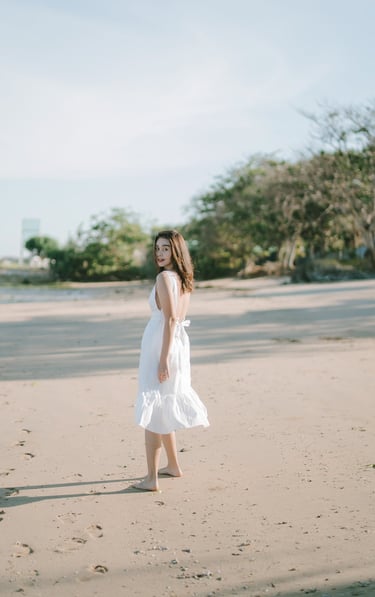 Woman walking on the beach during an intimate couple photography session at Novotel Bali Benoa in Tanjung Benoa Bali.