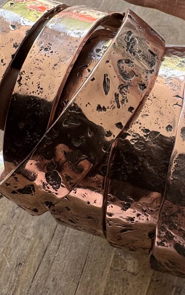 Copper cuffs textured with rocks and stones