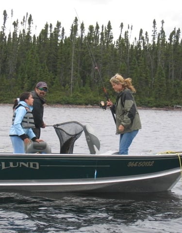 a man and woman fishing in a boat