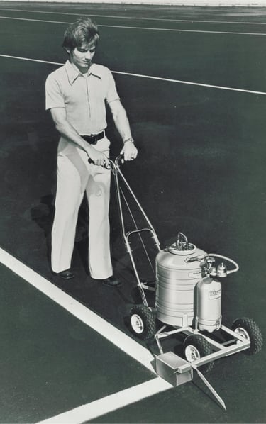 Painting a parking lot with a parking lot paint striping machine