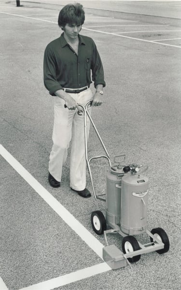 striping a parking lot using a trueline paint spraying machine