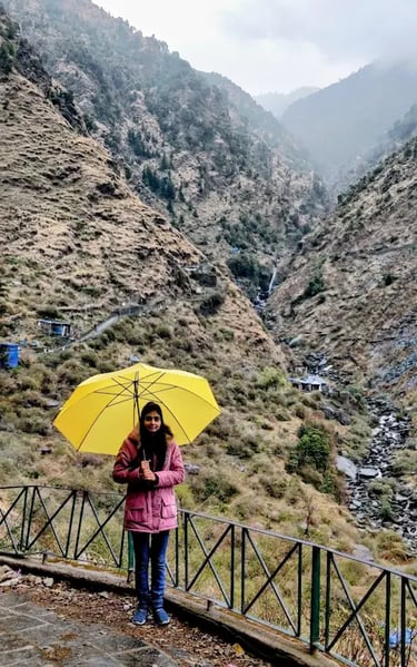 Scenic walking trail leading to Bhagsunag Waterfall in McLeod Ganj, surrounded by forested hills and mountain views.