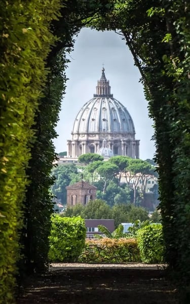View of St. Peter's Basilica through garden arch, Rome.