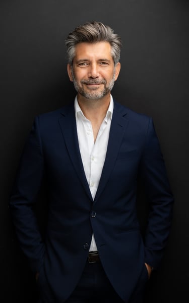 a man in a suit and white shirt