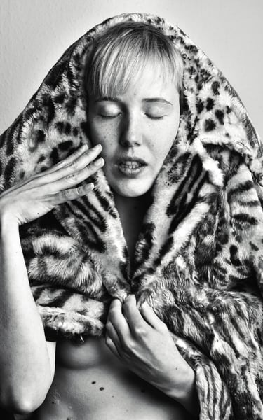 a woman in a leopard print coat and a leopard print coat posing for a photo