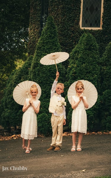 Children holding parasols at Avalon Castle Melbourne wedding outdoor ceremony momentChildren holding