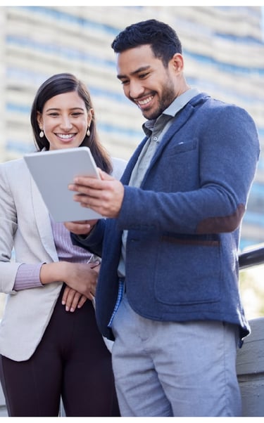 a man and woman standing in front of a building