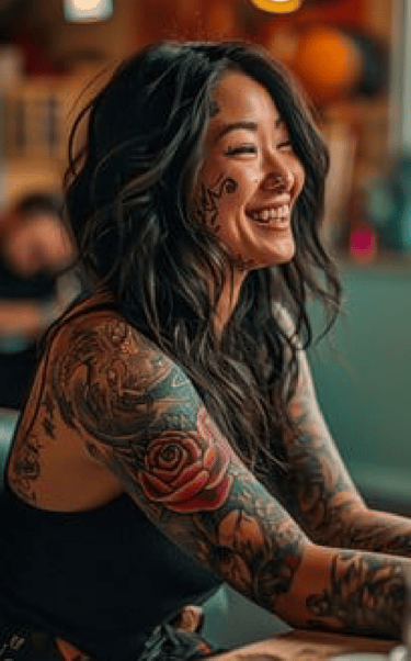 Image of a woman with tattoos smiling