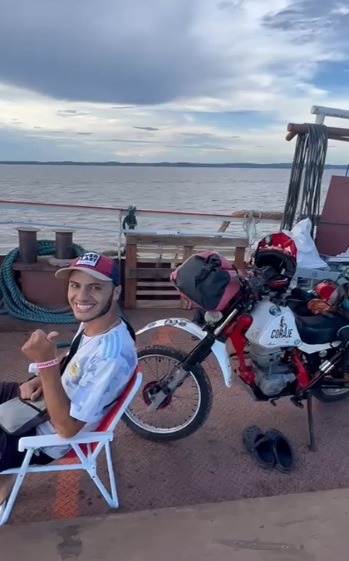 a man sitting in a chair with a helmet on