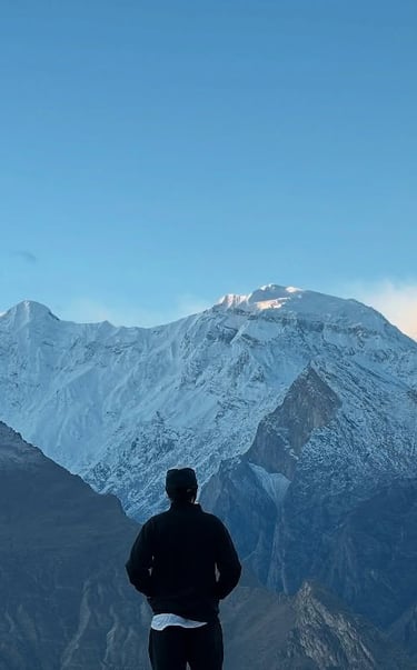 Akram Posh standing in front of Rakaposhi Mountain in Hunza Valley, Pakistan.