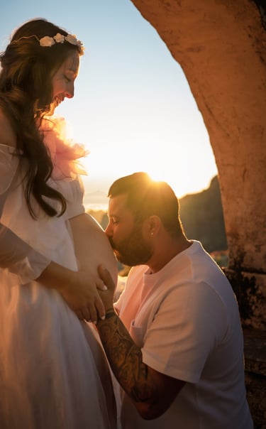 a pregnant woman is holding her belly while a man is holding her belly