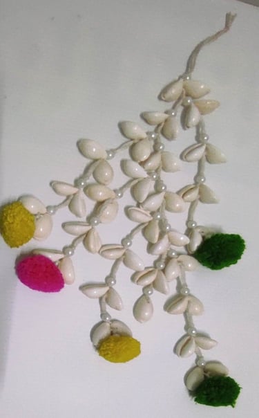 "Handmade shell hair tassel with colorful artificial flower ends–tribal-inspired accessory-Designed for export"