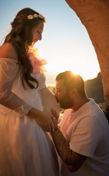 a pregnant woman is holding her belly while a man is holding her belly