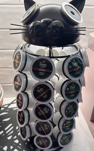 Black cat shaped coffee pod holder filled with assorted Peet's Coffee dark roast K-Cup capsules.