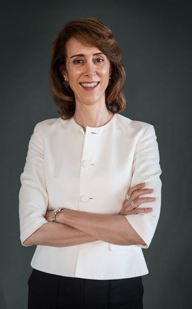 a female life coach in a white jacket and black pants