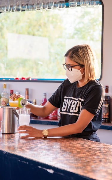 a masked girl serving lemonade at the bar on board the ark northampton