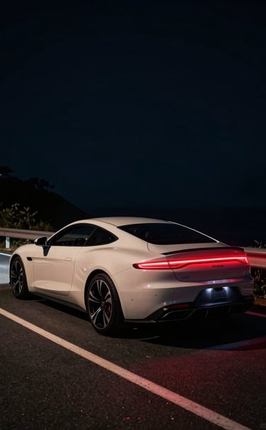 Cinematic wide shot of a high-end luxury car at night on a coastal road. Deep black shadows contrast with vibrant crimson red tail lights leaving long trails. Lighting is moody and sophisticated with soft off-white highlights on the car's curves.
