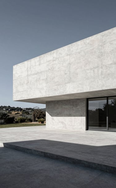 Professional architectural photography of a minimalist concrete villa in a Portuguese landscape. Midday sun creating sharp geometric shadows on Snow White and Midnight Grey surfaces. Clean lines and wide angle composition.