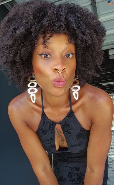 in oso a woman with a large afro - colored hair and piercings