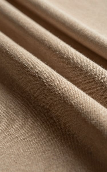 Detailed close-up photography of high-quality textured fabrics in warm beige and deep espresso brown. Soft, natural lighting highlights the intricate weave, creating a sense of tactile luxury in a Latinoamericano studio setting.