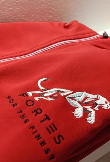 a red jacket with a white shirt and a red bag