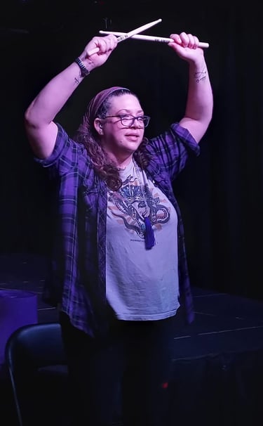 Hands up drumsticks crossed on stage