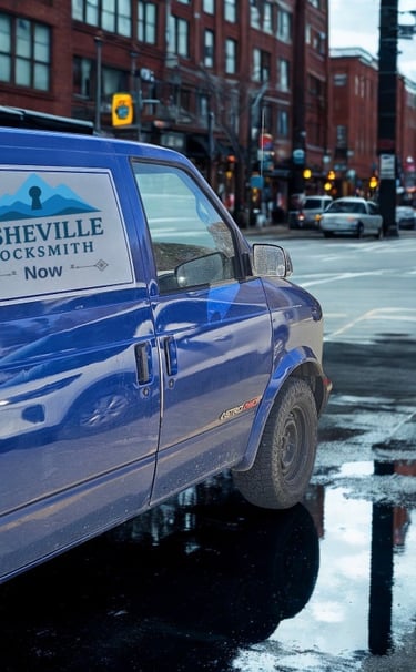 Blue Asheville Locksmith Now service van driving through West Asheville on rainy day