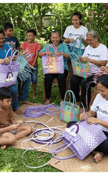 Community of artisans and families handcrafting colorful jali jali woven plastic bags together outdoors at craftvitas
