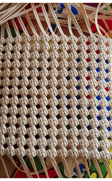 Base structure of a handmade woven bag using natural colored recycled plastic strips at Craftvitas Indonesia.