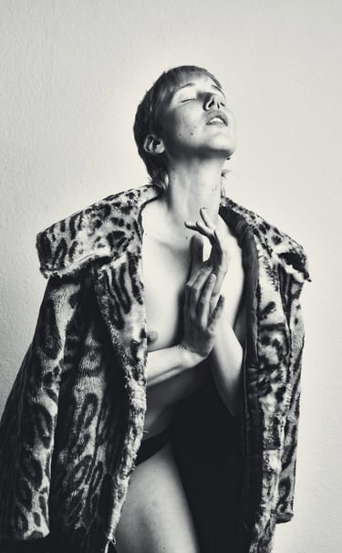 a woman in a leopard print coat and a leopard print coat posing for a photo