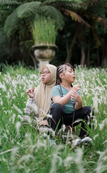 Sister and child sharing a quiet moment in an alang alang field during a Bedugul family photography session.