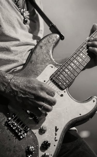 Extreme close-up photography of a musician's hands playing a dark electric guitar, sweat glistening under stage lights, high contrast between anthracite shadows and off-white highlights, raw energy, Western European / Dutch setting.