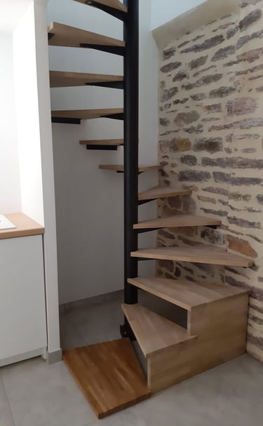 a spiral staircase with a wooden staircase in a stone wall