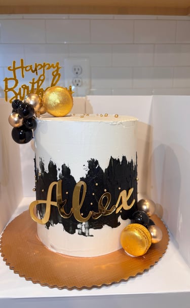 a cake with a gold birthday cake topper