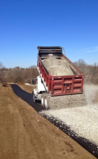 truck tail gating a gravel driveway