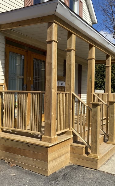 a porch with a wooden porch and a wooden porch