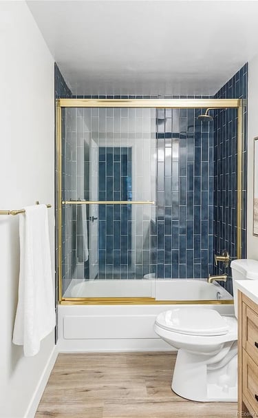 Modern cleaned bathroom with gold accents in Denver home by SparkEaseCleaning