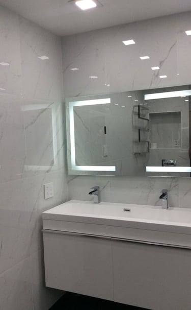 a bathroom with a large mirror and a sink