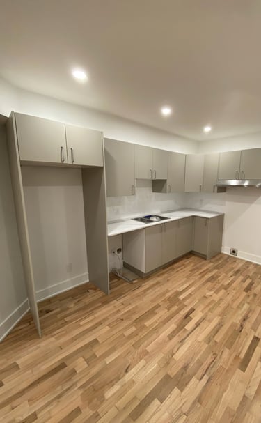 a kitchen with a wooden floor and a sink