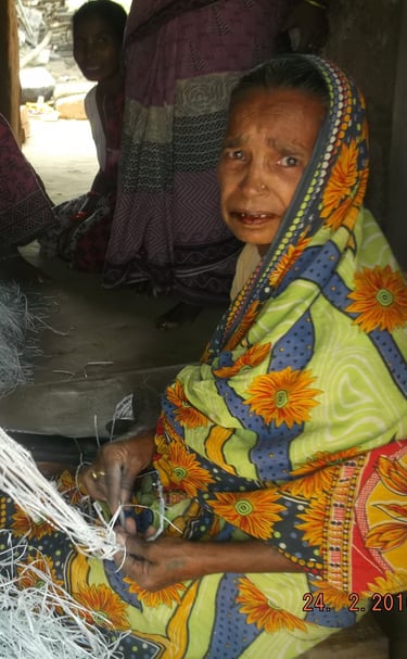 a woman in a brightly colored dress sitting on a chair