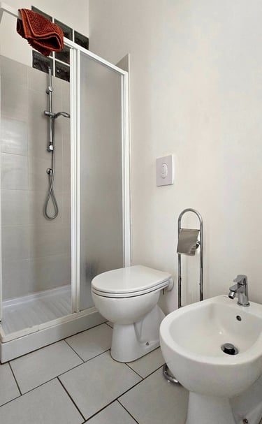 a bathroom with a toilet and a shower