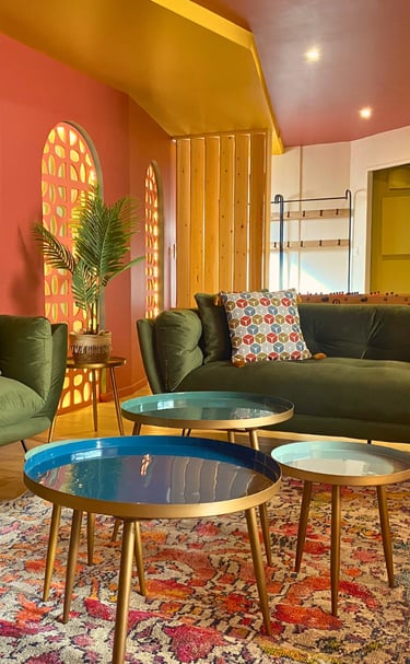Salon coloré avec canapés confortables et tables basses dans logement meublé pour pros.