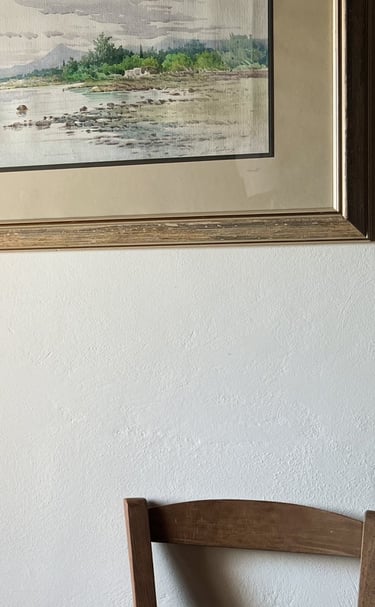 a table with three candles and a picture of a window