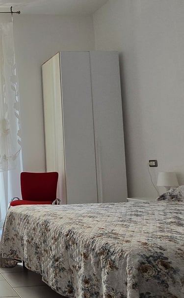a bedroom with a bed and a television