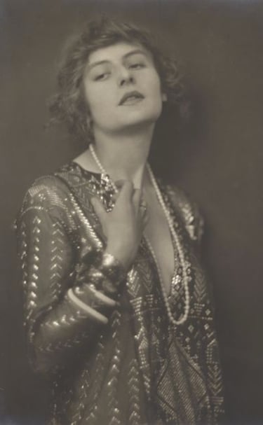 Black and white pho of Lady Carnarvon wearing Egyptian Assuit and pearls 1915