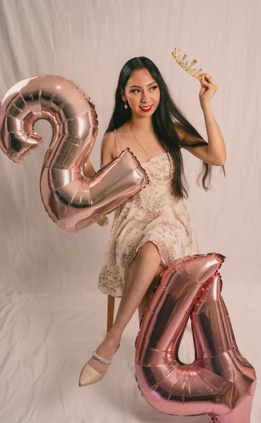 a woman in a dress and tiablet holding a crown