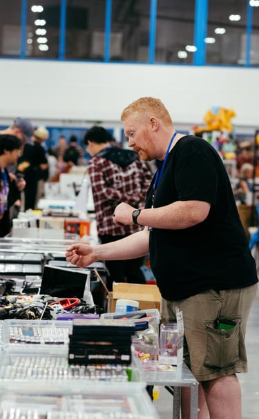 A collector looks through the video games for sale at a vendor booth