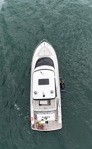 a boat with a man standing on the water