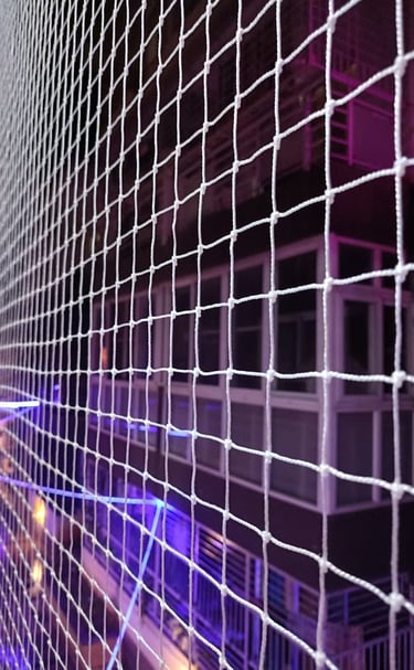 Wide shot of an open area surrounded by durable safety nets on Sarjapur Road.