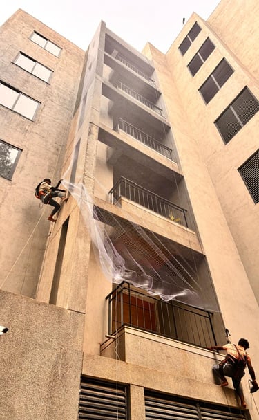 Bright morning view of a Whitefield apartment complex featuring clean, white safety nets protecting 